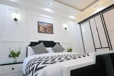 a bedroom with a bed with black and white pillows at Elbakry Hotel Luxor in Luxor