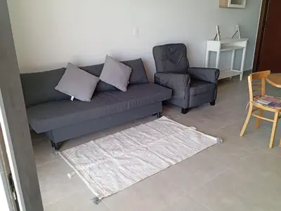 a living room with a couch and a chair at Charment Chalet Somabay in Hurghada