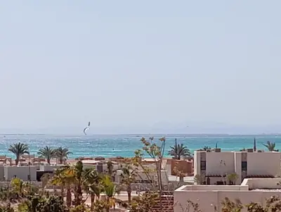 a view of a beach with buildings and the ocean at Charment Chalet Somabay in Hurghada