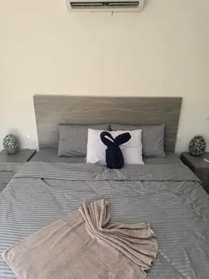 a bedroom with a large bed with a black ribbon at 304 aqua blue bay in Hurghada