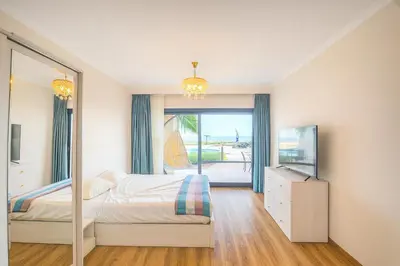 a bedroom with a bed and a large mirror at The View Hurghada Poolfront Sea View Apartment in Hurghada