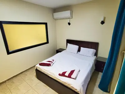 a bedroom with a bed with two towels on it at Poolside Chalet Ground Floor Aqua Park - BY MAMO Property in Hurghada