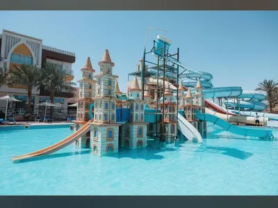a water park with a water slide in the water at Poolside Chalet Ground Floor Aqua Park - BY MAMO Property in Hurghada