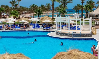 a pool at a resort with people swimming in it at Poolside Chalet Ground Floor Aqua Park - BY MAMO Property in Hurghada