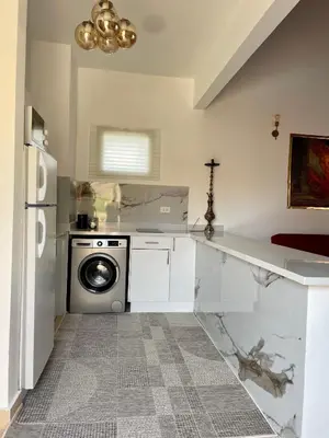 a kitchen with a washer and dryer in it at Casa Seherezade in Hurghada