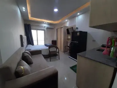 a living room with a couch and a bed and a kitchen at Casablanca beach in Hurghada