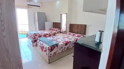 a living room with two beds and a table at Casablanca beach in Hurghada