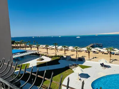 a view of a resort with a beach with umbrellas at The View Hurghada in Hurghada
