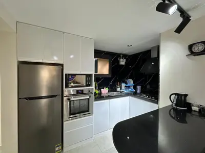 a kitchen with white cabinets and a stainless steel refrigerator at The View Hurghada in Hurghada