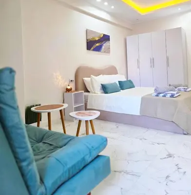 a bedroom with a king sized bed and a couch at Pool Dream Hurghada in Hurghada