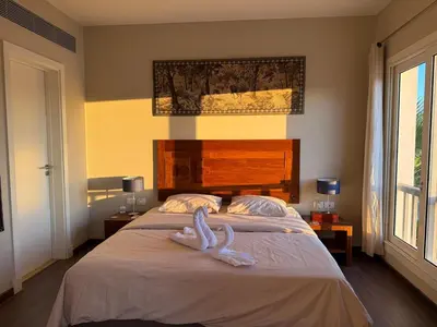 two swans sitting on a bed in a bedroom at The Nest Namaste - El Gouna in Hurghada