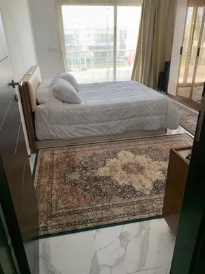 a bedroom with a bed with a rug and a window at Sky Star Villa 30 in Hurghada