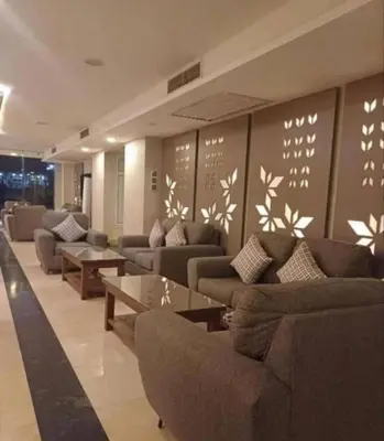 a lobby with couches and tables in a building at fanadir resort in Hurghada
