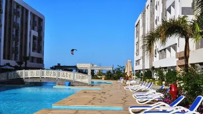a row of lounge chairs next to a swimming pool at Fanadir Chalet 3BR in Hurghada