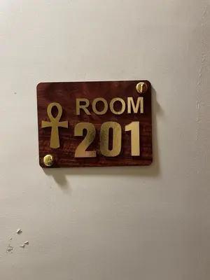 a sign on a wall that says room at Luxe Nest Luxor Serviced Apartments 201 in Luxor