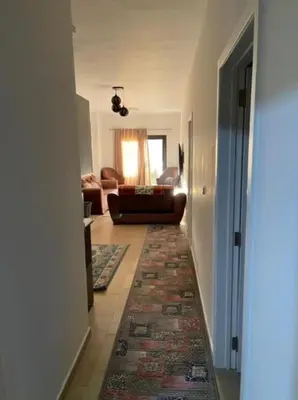 a hallway with a living room with a couch and a rug at Turtle beach resort in Hurghada