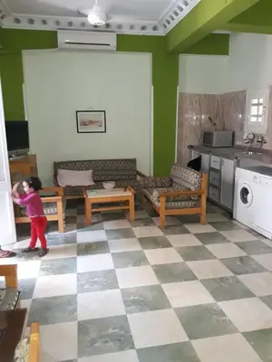 a little girl is standing in a living room at Obelisk house in Luxor