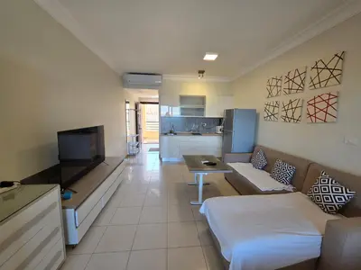 a living room with a couch and a kitchen at New studio in the view in Hurghada