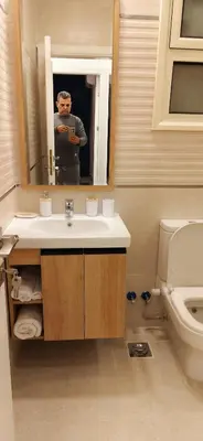 a man taking a picture in a bathroom mirror at Moon Hills Palace in Hurghada