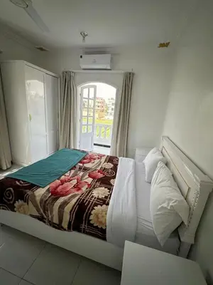 a large bed in a room with a window at Villa Shanhouri Nile View in Luxor