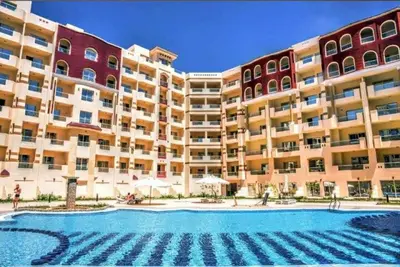 a large apartment building with a large swimming pool at Hurghada ,Mo&Kate Florenza Khamsin in Hurghada