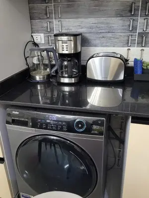 a washing machine in a kitchen with a counter top at Quiet, cozy resort apartment in Hurghada