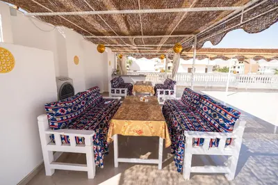 a dining room with a table and chairs at Home of ISIS in Luxor