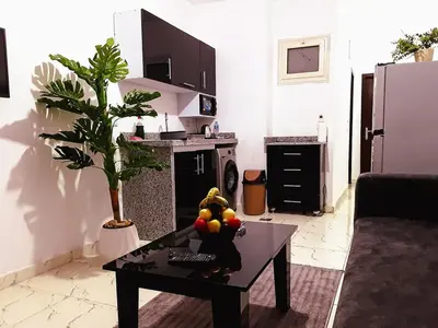 a living room with a table with fruit on it at stylish cozy one bedroom apartment in Hurghada