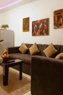 a living room with a couch and a table at stylish cozy one bedroom apartment in Hurghada