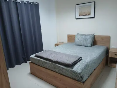 a bedroom with a bed and a blue curtain at Sea View 2 Bedroom Apartment in El-Hadaba in Hurghada