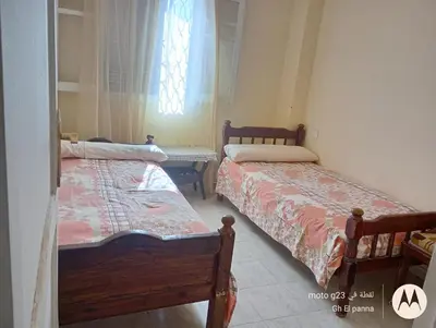 two beds in a room with a window at بيت فرح in Nag` el-Fuqâhi