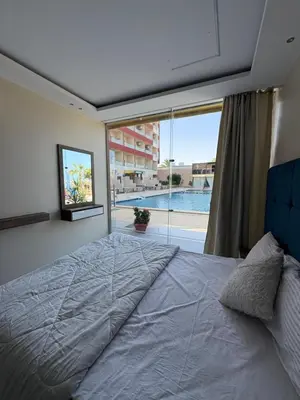 a bedroom with a large bed and a large window at Casablanca Star Hotel, Hurghada in Hurghada