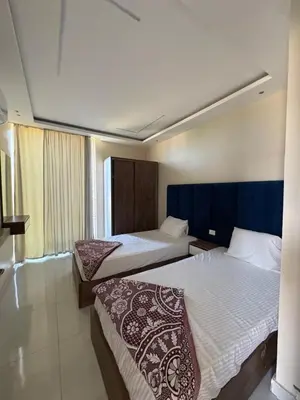 a hotel room with two beds and a window at Casablanca Star Hotel, Hurghada in Hurghada