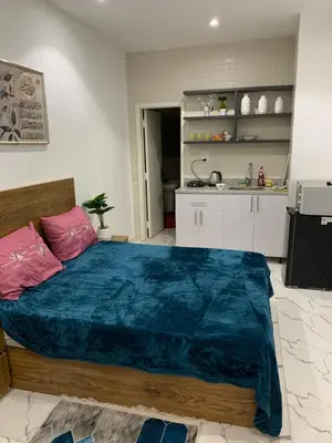 a bedroom with a large bed and a kitchen at Sea Light Arabia on the beach in Hurghada