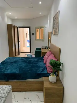 a bedroom with a large bed with a blue blanket at Sea Light Arabia on the beach in Hurghada