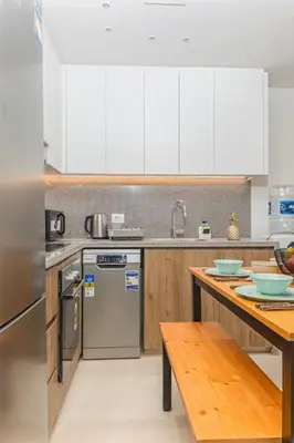 a kitchen with white appliances and a wooden table at Dreamy gateway in Ancient Sands in Hurghada