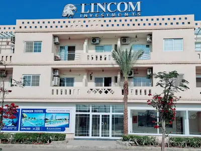 an exterior view of a hotel with a palm tree at Hurghada Resort in Hurghada