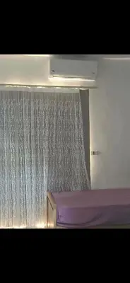 a bedroom with a window with a shower curtain at Al helal in Hurghada