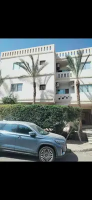 a blue car parked in front of a building at Al helal in Hurghada