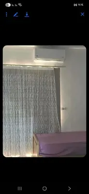 a bedroom with a window with a shower curtain at Al helal in Hurghada