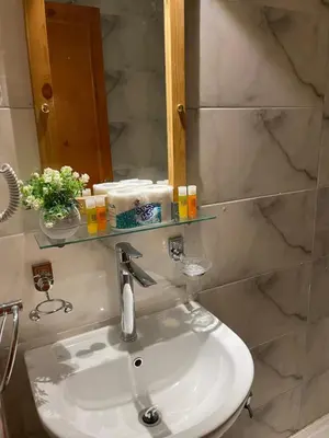 a bathroom with a sink and a mirror at Luxe Nest Luxor Serviced Apartments 202 in Luxor