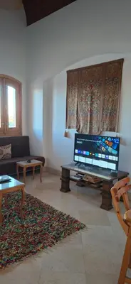 a living room with a large flat screen tv at El Gouna Upper nubia in Hurghada