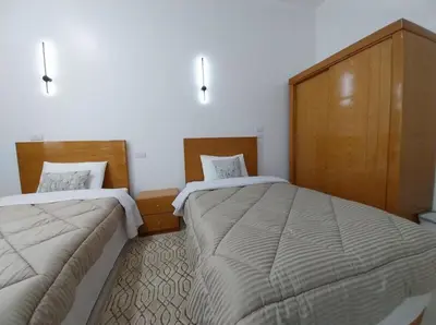 a room with two beds in a room at Desert Daisy in Luxor