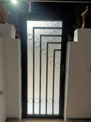 a door with a window with a metal grate at Desert Daisy in Luxor