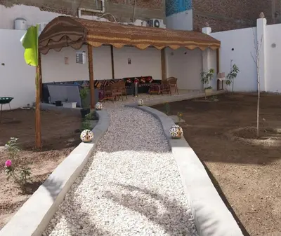 a backyard with a gazebo and a house at Desert Daisy in Luxor