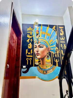 a painting of a woman with a crown on a wall at Luxor Temple & Local Life at Your Doorstep Al FahadAprtments in Luxor