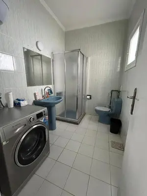 a bathroom with a washing machine and a sink at Pause by The Sea Hurghada, Stay, Relax, Repeat in Hurghada