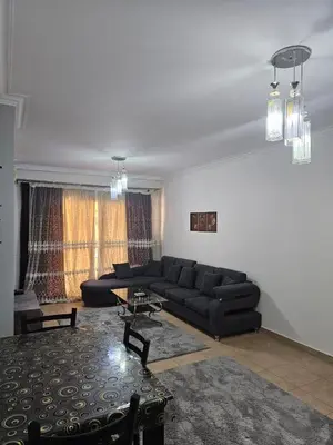 a living room with a couch and a table at الكوثر المنتجع البريطاني البريتش ريزورت in Hurghada