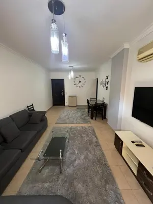 a living room with a couch and a tv at الكوثر المنتجع البريطاني البريتش ريزورت in Hurghada