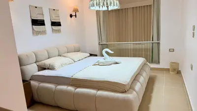 a bed in a room with a couch at Kuba luxury loft in Hurghada